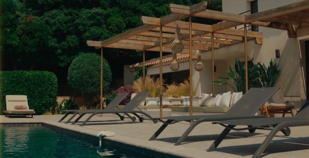 Terrace with panoramic sea view over the Gulf of Saint-Tropez, outdoor area furnished with designer furniture and swimming pool, luxury villa in Les Issambres available for seasonal rental.